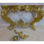 A 19th century Rococo gilt wood and gesso console table, some pieces need re attaching, lacking