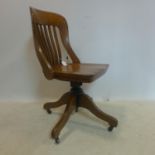 An early 20th century oak swivel desk chair