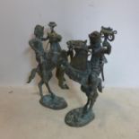A large pair of early 20th century Dutch cast bronze candle stick holders, in the form of a figure