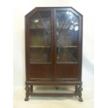 An Art Deco style display cabinet, glazed doors, on stand with turned supports, H.145 W.88 D.29cm