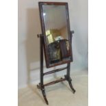 A 19th century mahogany cheval mirror, raised on splayed legs and castors
