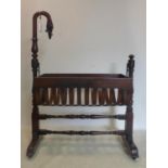 A Victorian mahogany rocking crib on stand, with swan neck finial, H.103 W.104 D.59cm