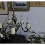 A pair of chrome plated chandeliers and 4 matching wall lights