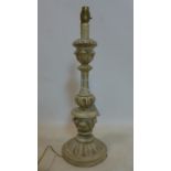 A carved wooden candlestick converted to a table lamp, with floral decoration, no shade, H.50cm