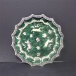 An 18th century Chinese Kangxi famille verte dish, decorated with horses frolicking in a field,