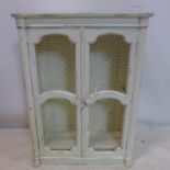 A painted wall hanging cabinet with chicken wire doors, H.81 W.60 D.26cm