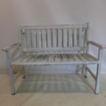 A weathered teak garden bench