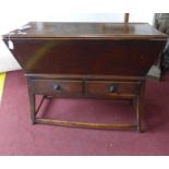 An early 19th century elm dough chest, having two short drawers, raised on splayed tapered legs