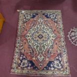 A Central Persian Bakhtiari rug, central double pendent medallion on a terracotta field, within