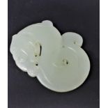 A Chinese pale green carved jade pendant depicting a stylised serpent, 6 x 5cm, 41.8g