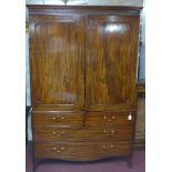A Regency mahogany linen press, the 2 panelled doors enclosing 5 linen trays and brass hanging rail,