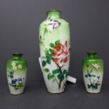 Three late 19th/early 20th century Japanese cloissonne enameled vases, decorated with blossoming