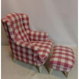 A contemporary wing back armchair and matching foot stool