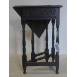 An Art Nouveau ebonized drop leaf table