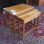 A 20th century teak nest of three tables, the smallest with a drawer, H.54 W.60 D.39cm