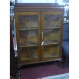 An early 20th century glazed oak bookcase, H.121 W.91 D.45cm