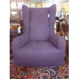 A contemporary purple wing back armchair by Natuzzi