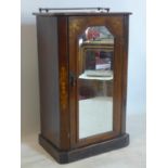 A Victorian marquetry inlaid mahogany music cabinet