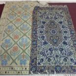 Two Kashmiri embroidered rugs, to include one with central floral medallion and stylised floral