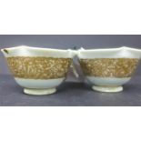 A pair of Japanese white and gilt Imperial style teacups, decorated with a gilt continuous band of