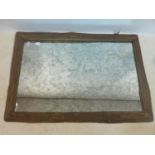 A rustic framed wall mirror, with antiqued glass plate, 139 x 101cm
