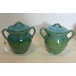 A pair of Persian cyan glazed pots and covers, with rope twist design handles, H.33cm (2)