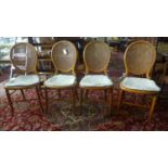 A set of 4 Victorian walnut balloon back dining chairs, with cane seats and back rests