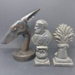 Two Victorian cast iron door stops, together with an Art Deco wood carving of a dog's head