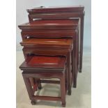 A 20th century Chinese hard wood nest of 4 tables