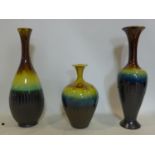 Three Persian drip glazed vases of varying size and form, H.50cm (largest)