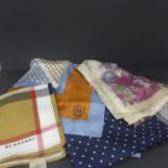 A collection of four scarves, to include a cotton Burberry scarf, a Massimo Dutti Italian silk scarf