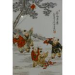 A Chinese porcelain plaque painted with children playing, set in hardwood frame, 40 x 29cm