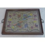 An early 20th century mahogany serving tray, inset with floral stump work panel under glass, 42 x