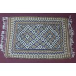 An antique Kilim rug with geometric design, on a blue and beige ground, 164 x 115cm
