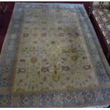 A large 20th century Persian carpet with repeating geometric motifs, on a beige ground, contained
