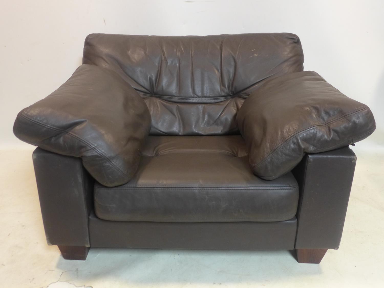 A Heal's brown leather armchair, with makers label