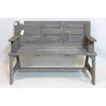 A weathered teak metamorphic garden bench