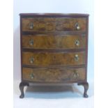 An early 20th century walnut bow front chest of four drawers, raised on cabriole feet, H.78 W.63 D.