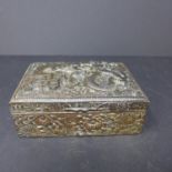 A Chinese silver plated box, decorated with flowers, a dragon and Chinese characters, hinge