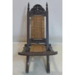 A 19th century Anglo-Indian carved hardwood folding chair with rattan seat and back rest