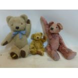 Two vintage Merry thought teddy bears together with a pink teddy bear by jolly berry bears