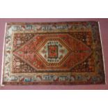 A north west Persian Zanjan rug, the central diamond medallion on a terracotta field, within a
