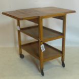 A 1930's oak metamorphic drinks trolley, raised on castors, H.79 W.88 D.47cm