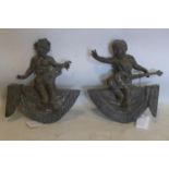 A pair of 19th century bronze finials in the form of child musicians on swags, 30 x 26cm