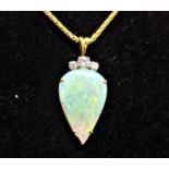 An 18ct yellow gold, opal and diamond set pendent with matching earrings