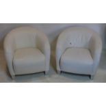 A pair of Natuzzi white leather armchairs on chrome bases