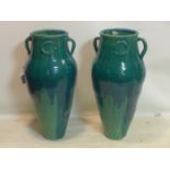 A pair of Persian green glazed Sharab wine vessels, H.90cm
