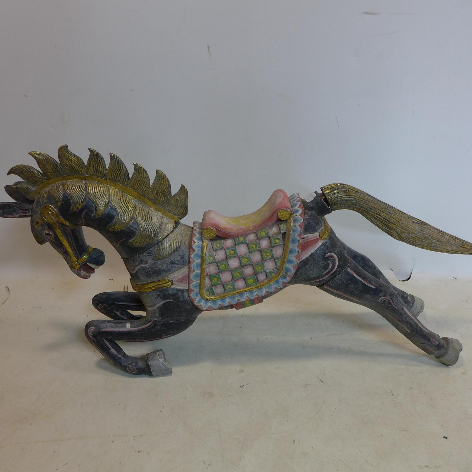 An early 20th century Indonesian carved sectional wooden horse, poly-chrome painted, H.60 W.124 D.