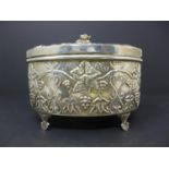 A Judaic silver box, repousse decorated with grape vines, scrolling foliage and Hebrew script, on