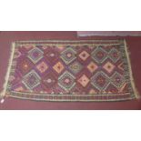 An antique Kilim carpet with geometric design, in colours of pink, blue, beige and purple, 266 x